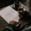 man writing journal desk Masonic education