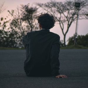 man sitting quietly reflecting outdoors Masonic education