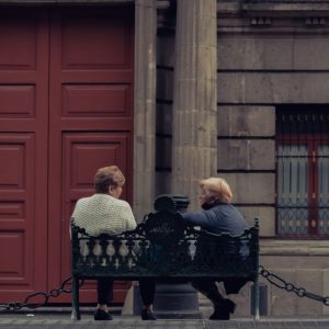 two friends sitting bench outdoors Masonic education