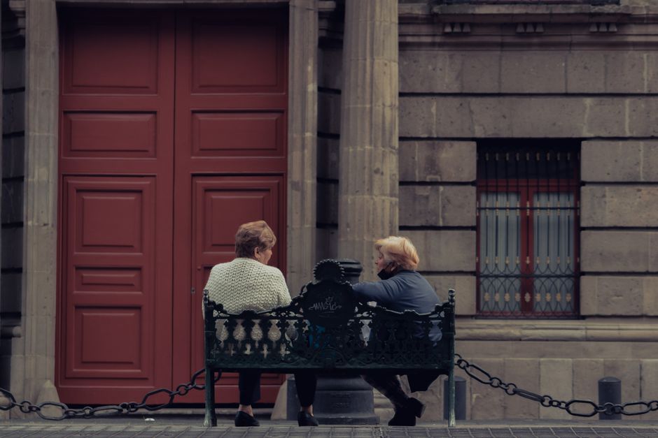 two friends sitting bench outdoors Masonic education