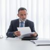 calm businessman seated at table Masonic education