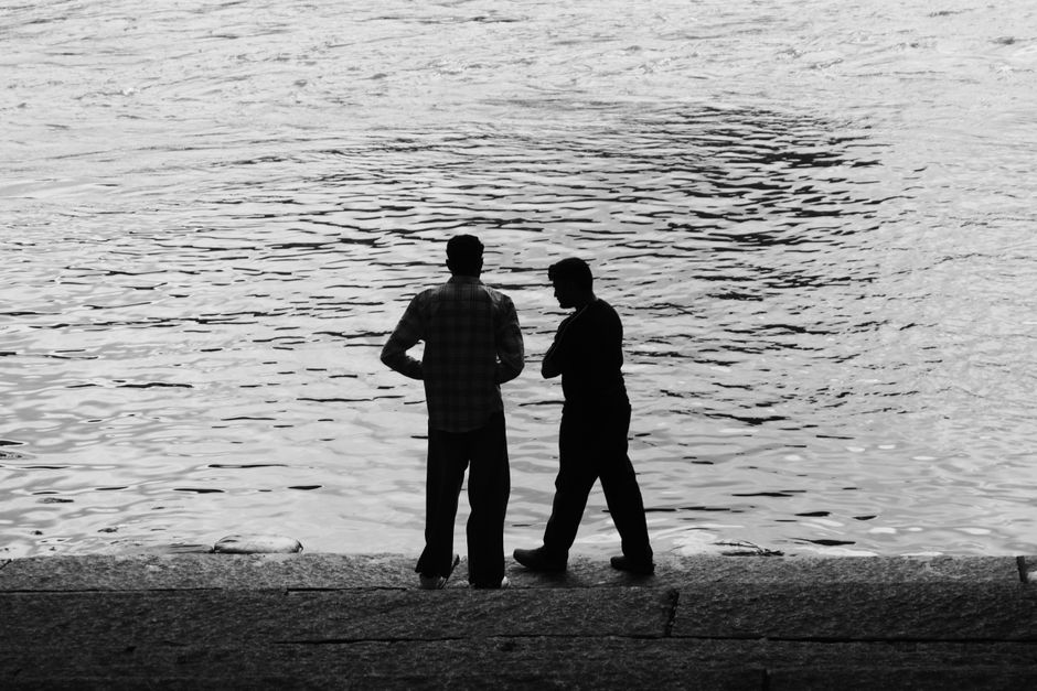 two men sitting dock talking Masonic education