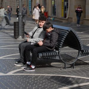 older man younger man talking bench Masonic education